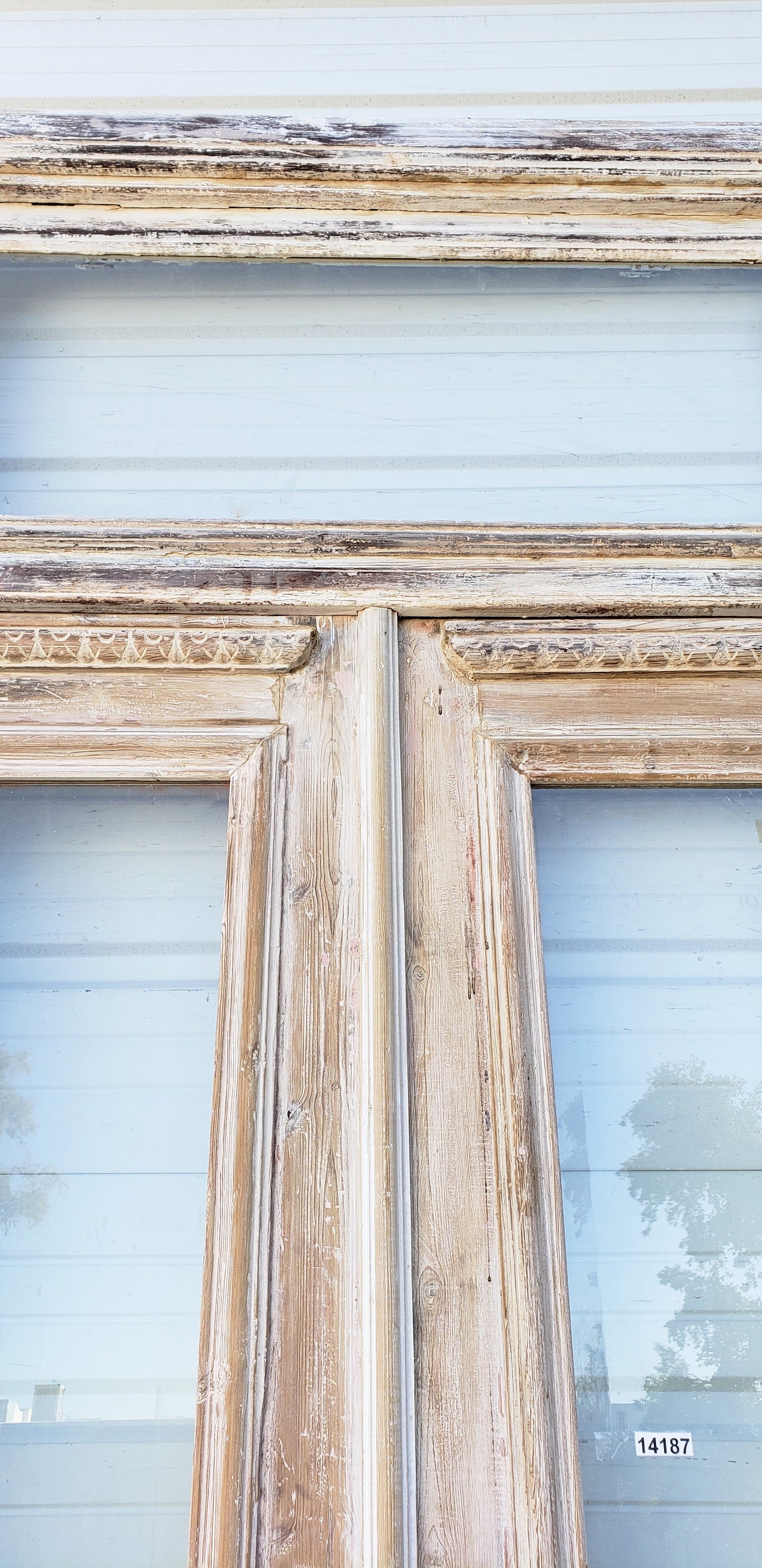 Pair of Washed Antique Wood Single Lite French Carved Doors with Transom Window