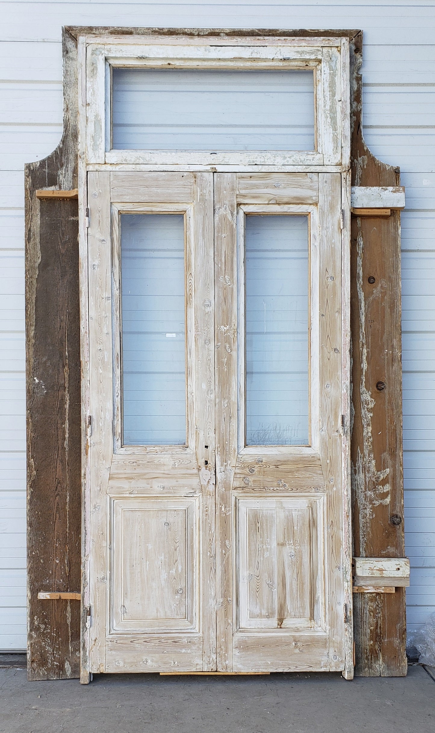 Pair of Washed Antique Wood Single Lite French Carved Doors with Transom Window