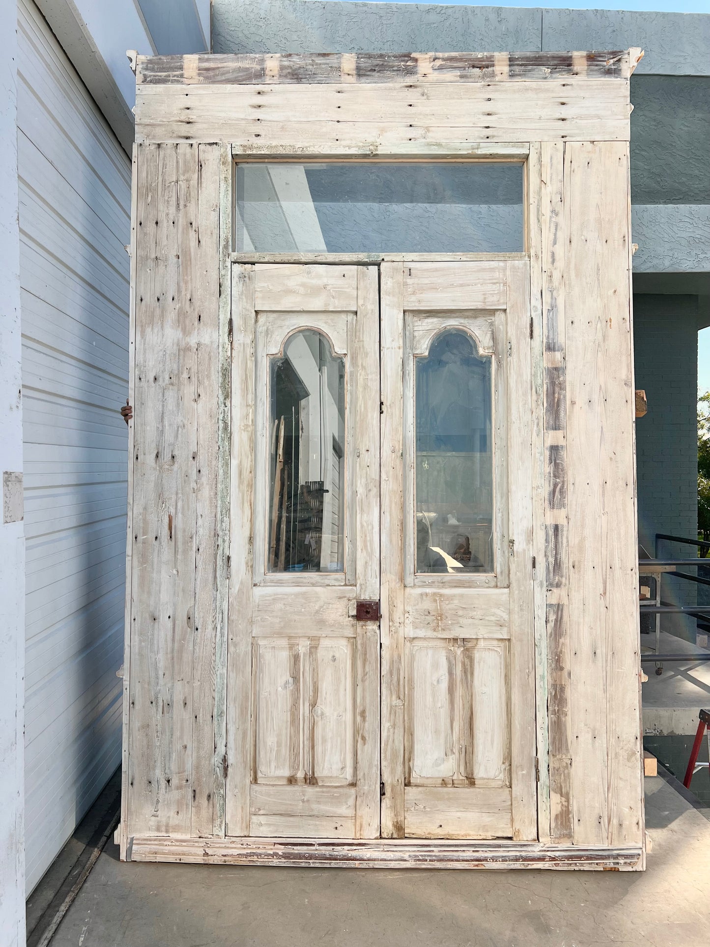 Pair of Ornately Carved Antique Doors in Large Frame with Transom