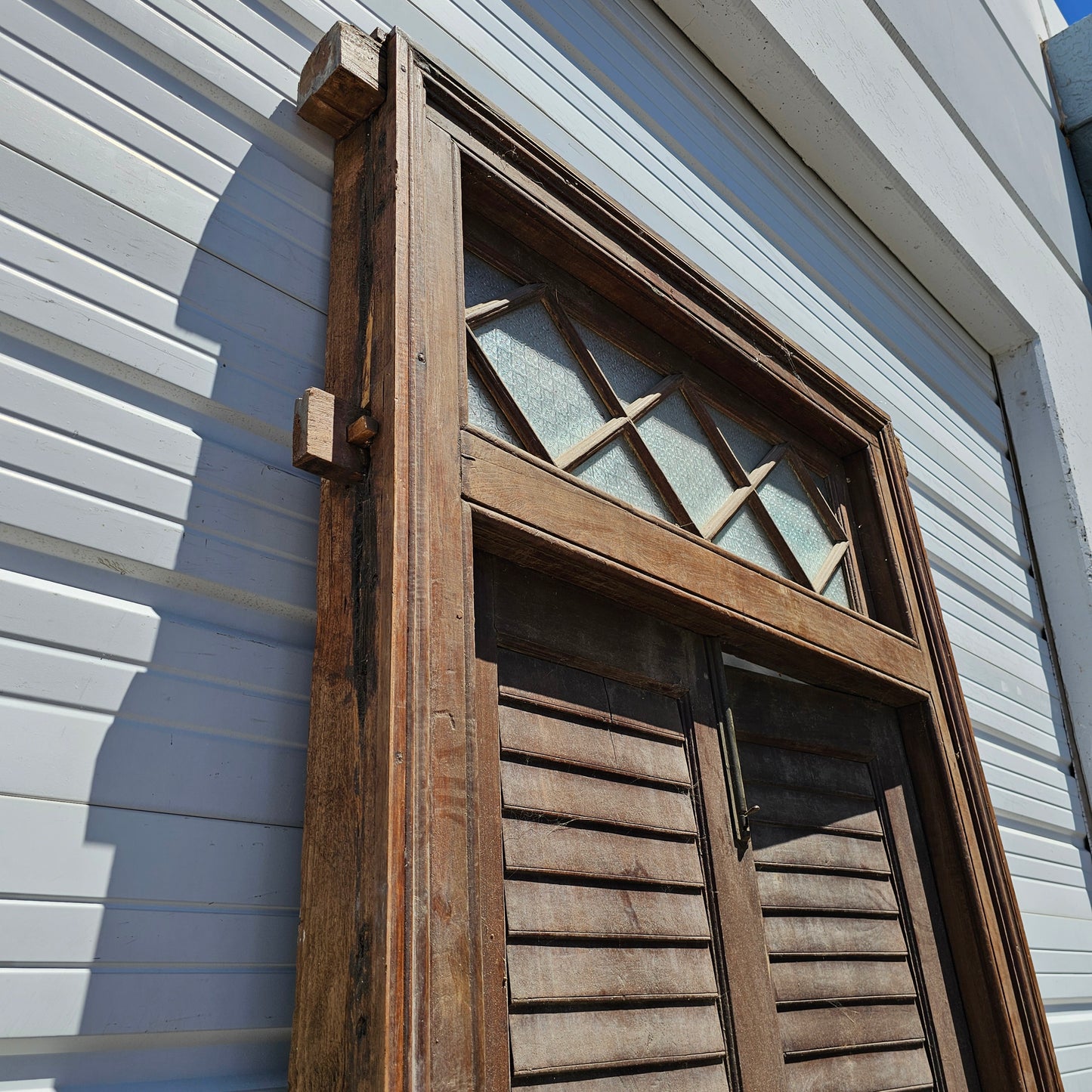 Pair of Wood Shuttered Doors with Glass Transom in Frame