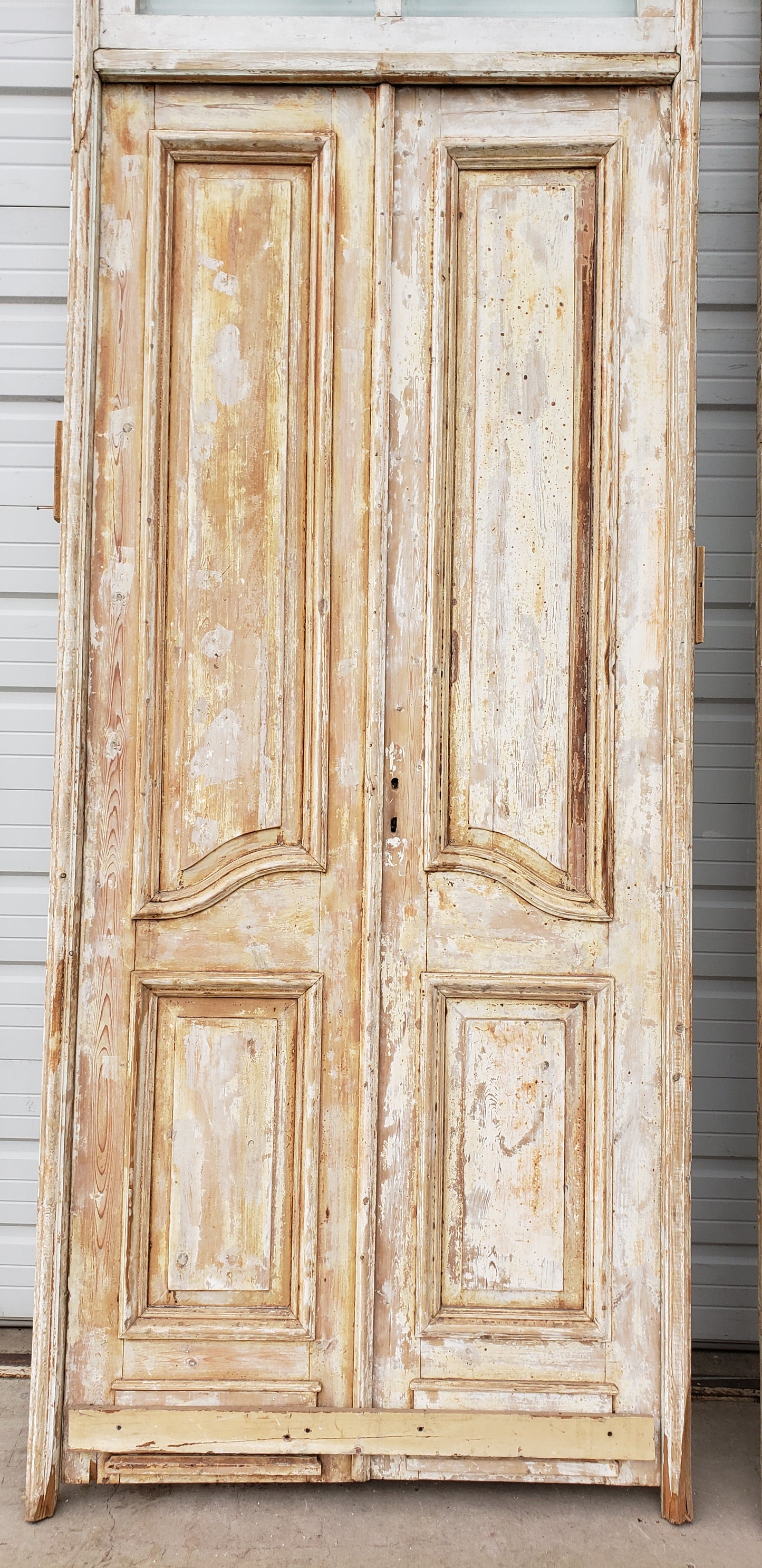 Pair of Framed 3 Panel Distressed Antique Doors with Circle Transom