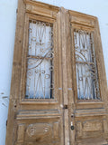 Pair of Carved Natural Wood Antique Doors with Iron Inserts