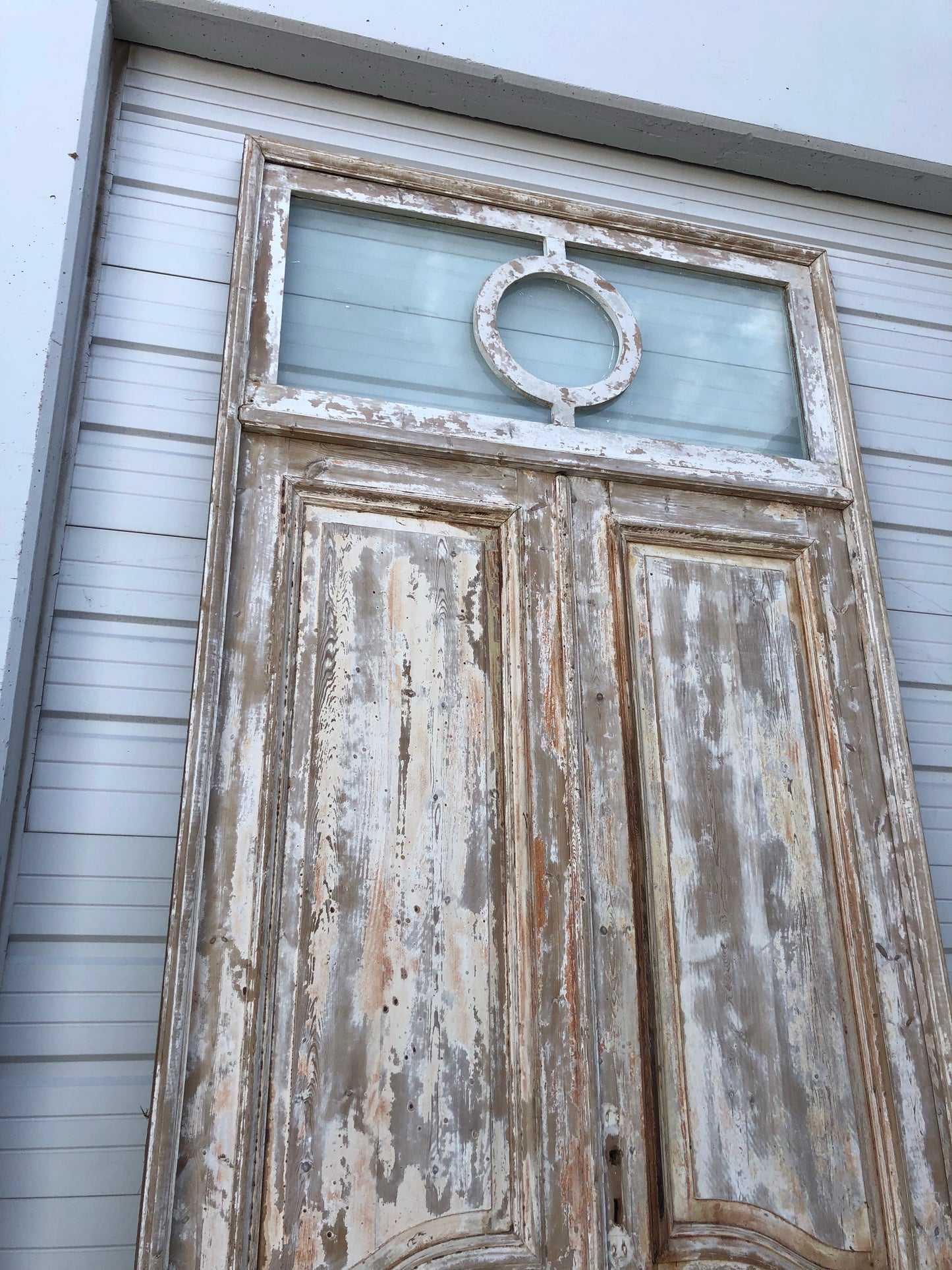 Pair of Framed 3 Panel Distressed Antique Doors with Circle Transom
